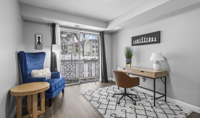 a room with a table chairs and a window