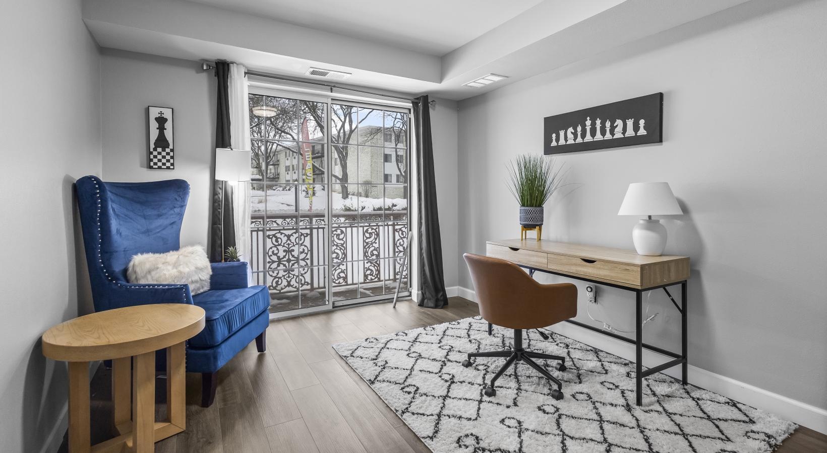 a room with a table chairs and a window