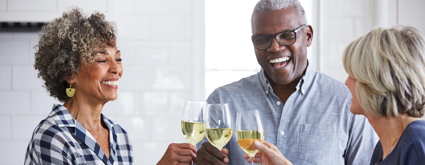 a few people toasting wine glasses
