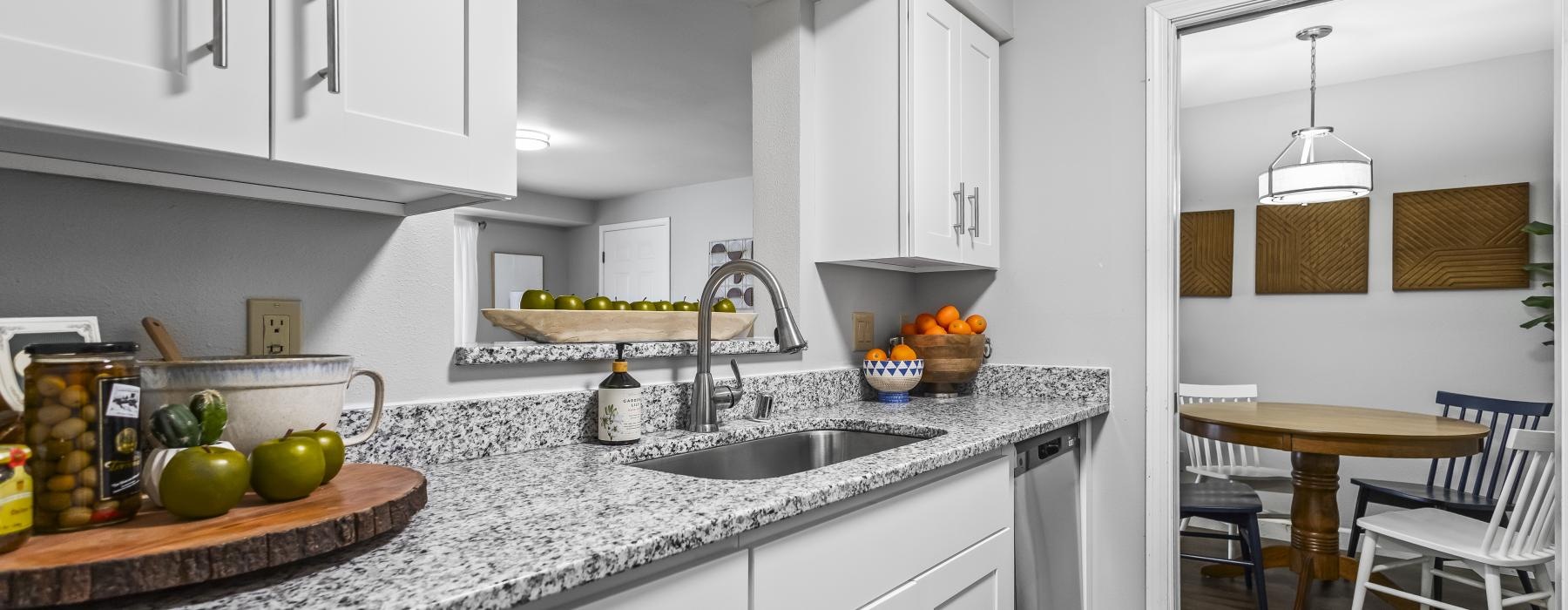 a kitchen with white cabinets